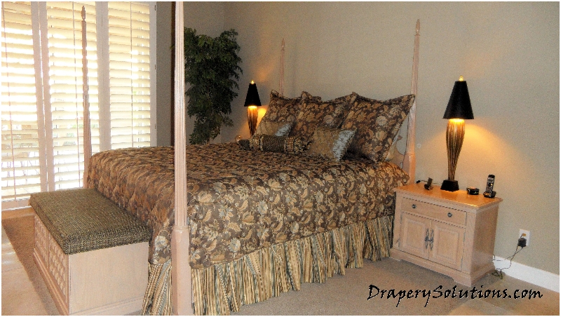 Quilted coverlet with split corners over shirred dust ruffle by Drapery Solutions.