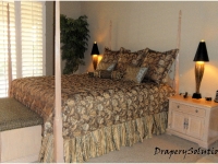 Quilted coverlet with split corners over shirred dust ruffle by Drapery Solutions.