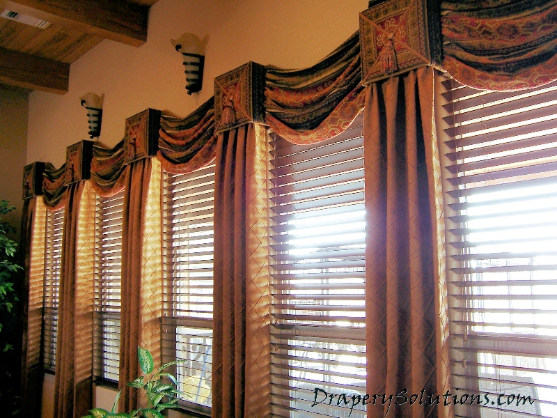 Cornices with swags and southwestern fabric panels by Drapery Solutions.