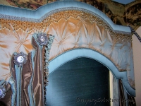 Arched cornice with trim bandings and panels by Drapery Solutions.