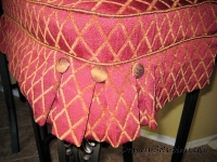 Box pleat and button on chair cushion by Drapery Solutions.