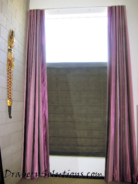 Ripplefold panels with top-down bottom-up roman shade by Drapery Solutions.