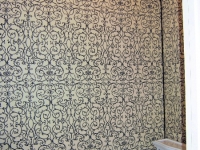 Upholstered walls in powder room by Drapery Solutions.